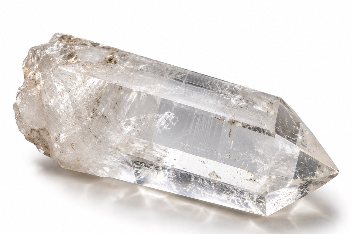 A natural clear quartz point photographed in soft light