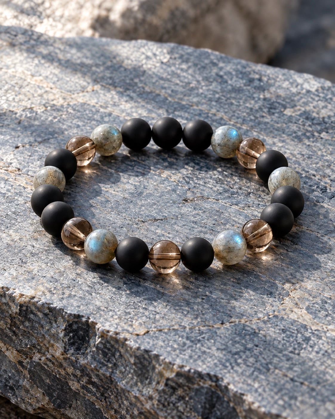 Onyx, labradorite and smoky quartz bracelet on grey stone