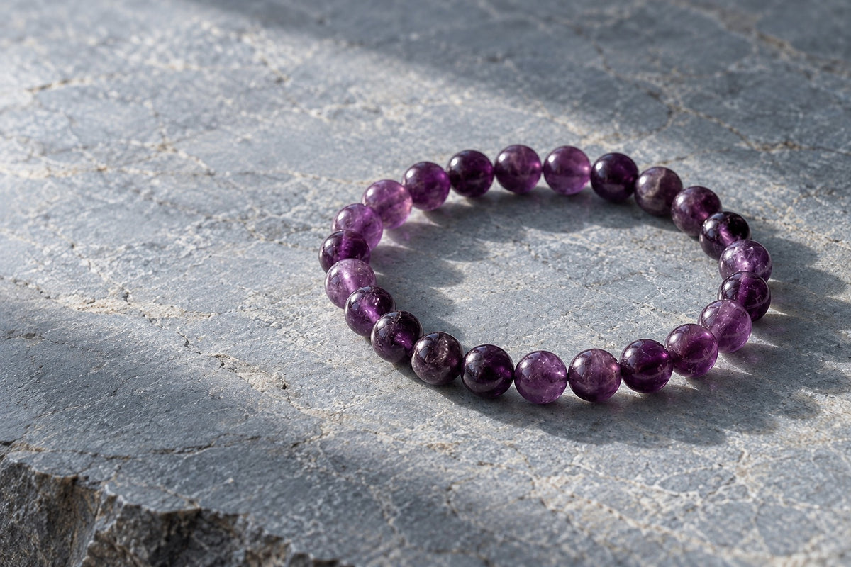 Amethyst bead bracelet on grey stone