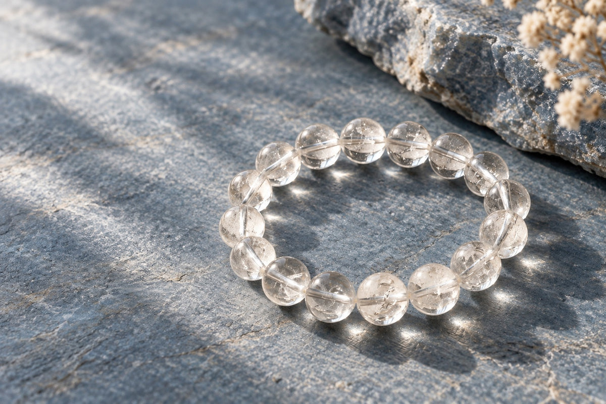 Clear quartz bead bracelet on grey stone in soft light