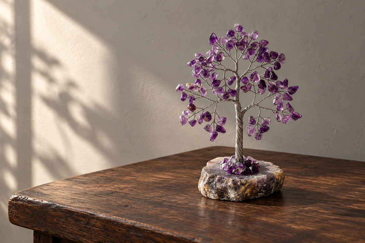 Amethyst crystal tree on a dark wooden table in soft light