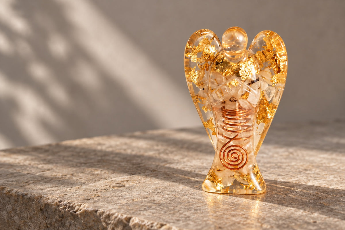 Citrine resin angel with a copper spiral on pale stone