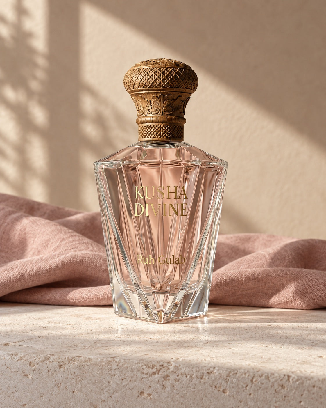 KUSHA DIVINE attar bottle with a carved wooden cap beside soft pink linen