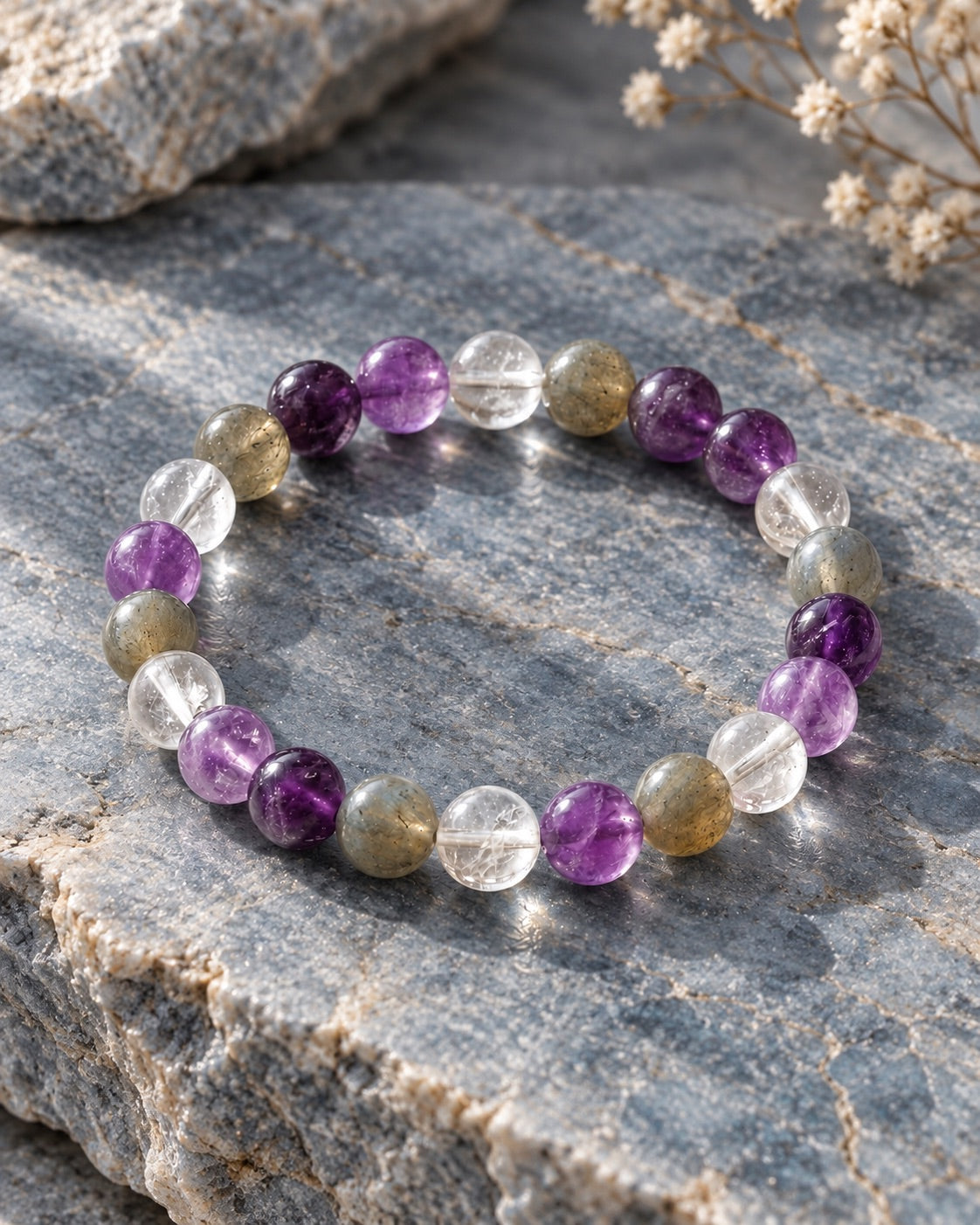 Amethyst, clear quartz and labradorite bracelet on grey stone for Mulank 7