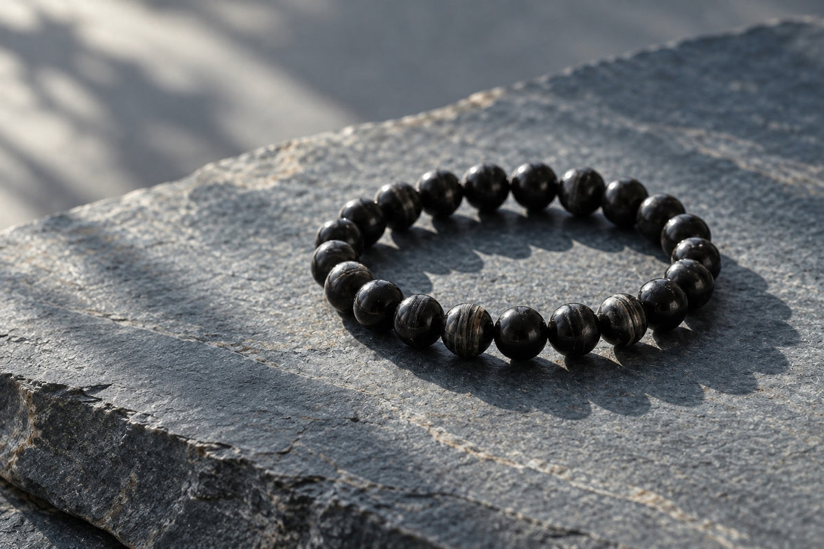 Black stone bead bracelet on dark slate