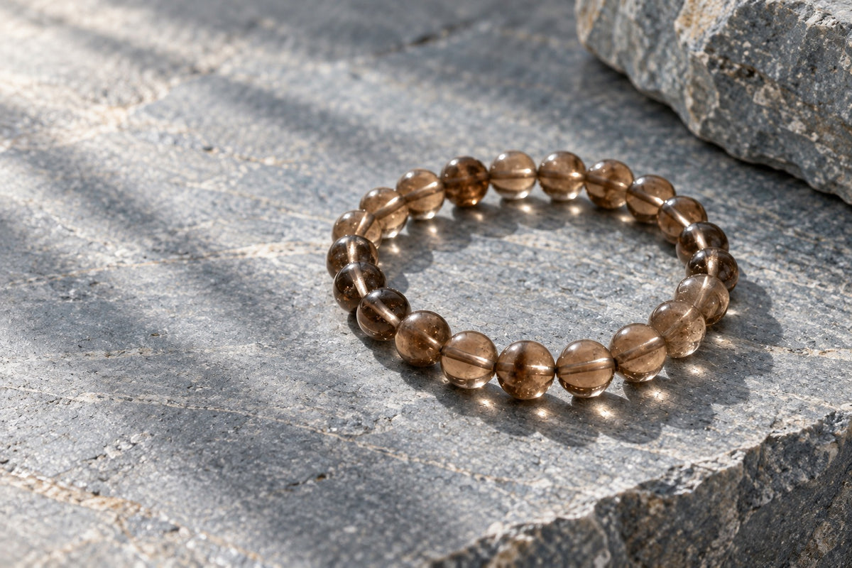 Smoky quartz bead bracelet on grey stone for Scorpio