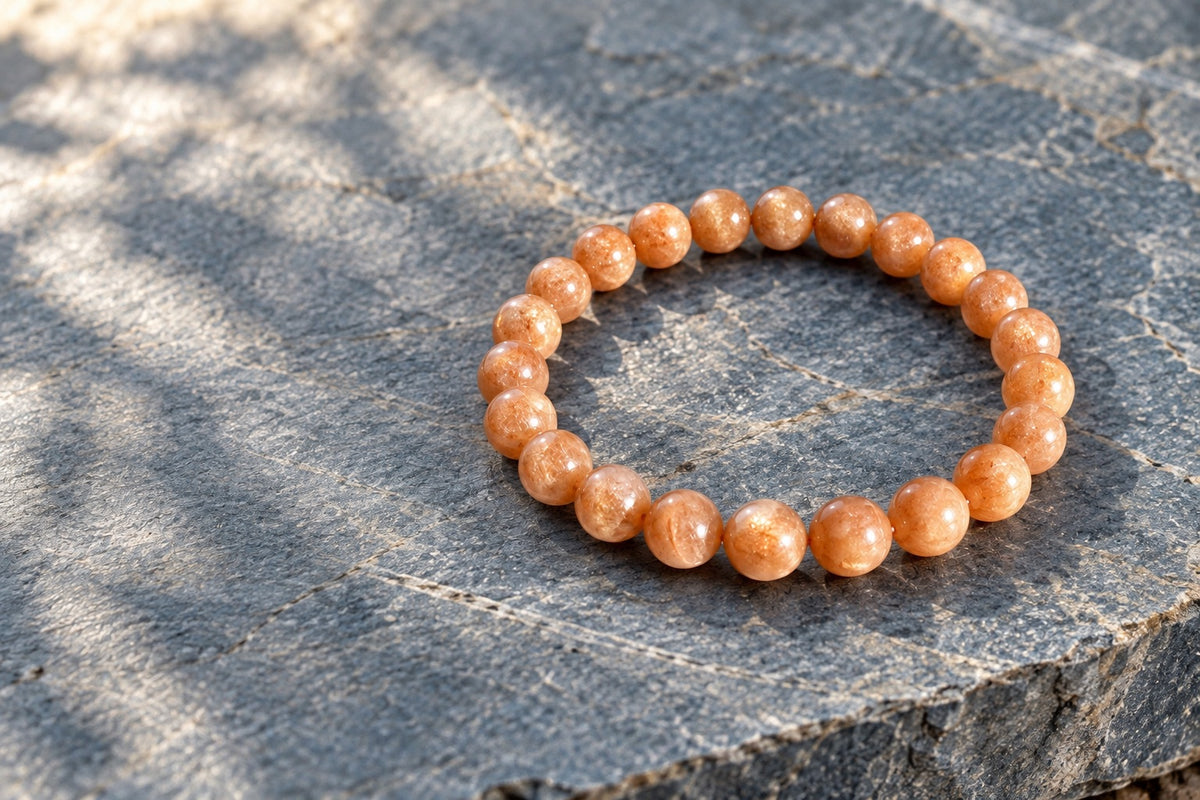Sunstone bead bracelet on grey stone