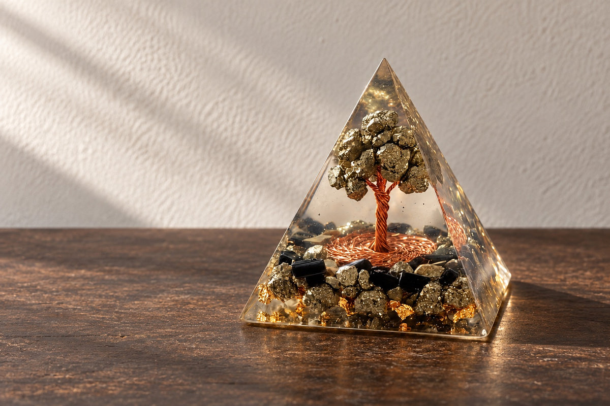Pyrite tree of life resin pyramid on a dark wooden table